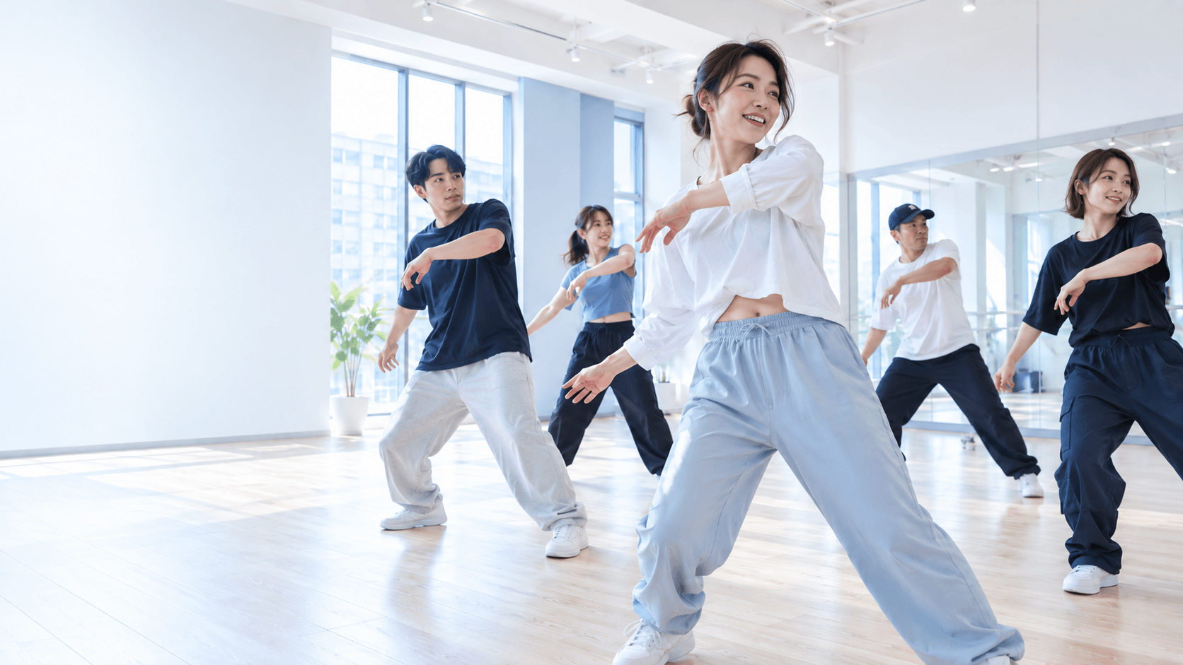 明るいスタジオで一緒にダンスを楽しむ大人の仲間たち